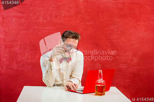 Image of Young funny man with laptop at St. Valentine\'s Day