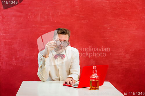 Image of Young funny man with laptop at St. Valentine\'s Day