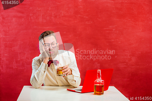 Image of Young funny man with laptop at St. Valentine\'s Day