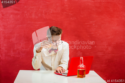 Image of Young funny man with laptop at St. Valentine\'s Day