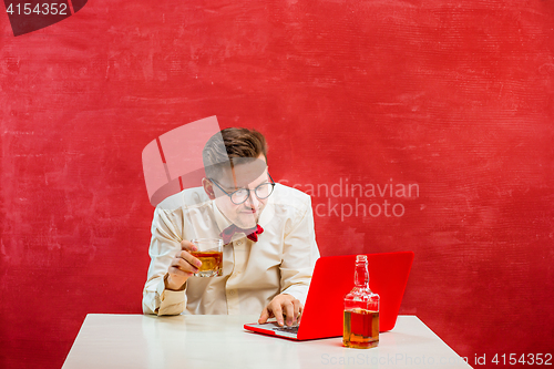 Image of Young funny man with laptop at St. Valentine\'s Day