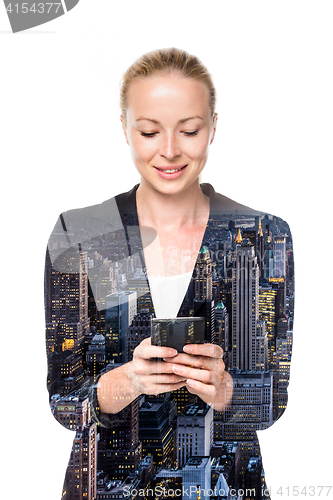 Image of Beautiful young caucasian businesswoman using mobile phone.