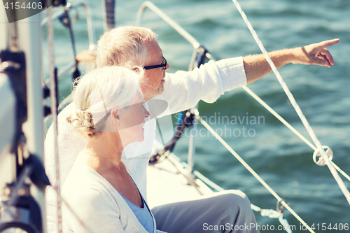 Image of happy senior couple on sail boat or yacht in sea