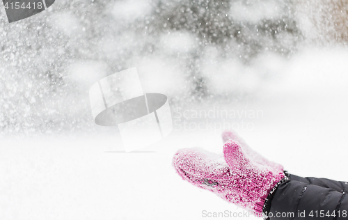 Image of close up of woman throwing snow outdoors