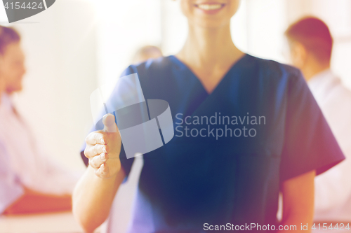 Image of close up of doctor reaching out hand at hospital