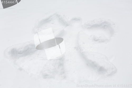 Image of angel silhouette or print on snow surface