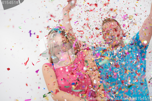 Image of romantic young  couple celebrating  party with confetti