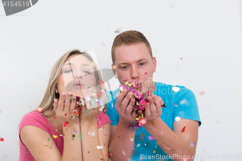 Image of romantic young  couple celebrating  party with confetti