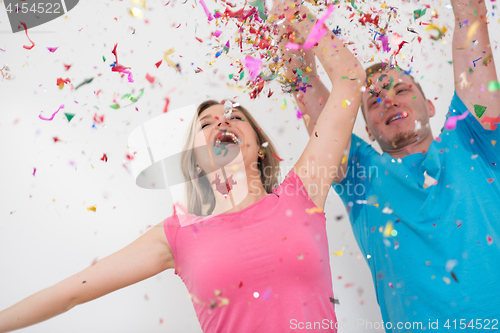 Image of romantic young  couple celebrating  party with confetti