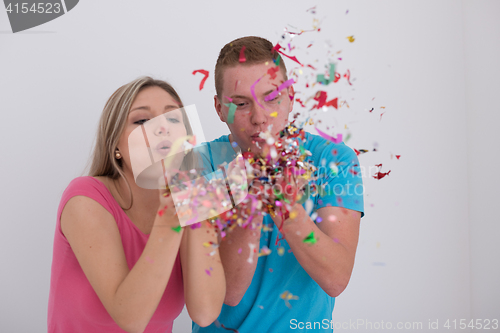 Image of romantic young  couple celebrating  party with confetti