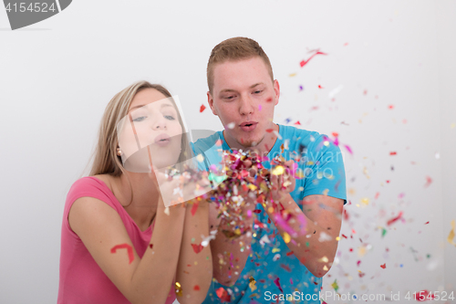 Image of romantic young  couple celebrating  party with confetti