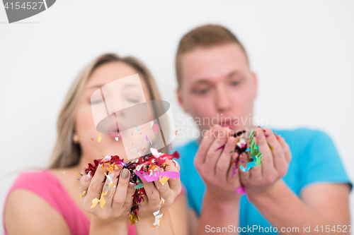 Image of romantic young  couple celebrating  party with confetti