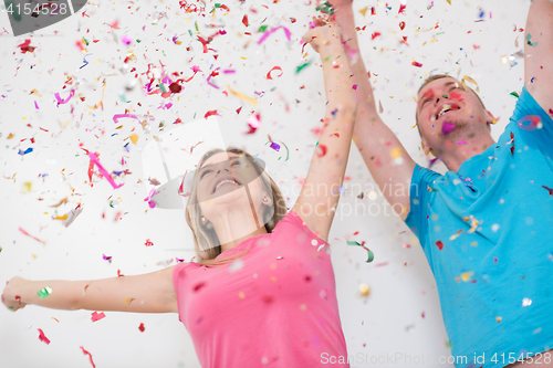 Image of romantic young  couple celebrating  party with confetti