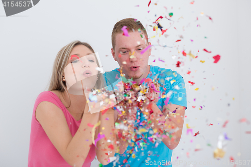 Image of romantic young  couple celebrating  party with confetti