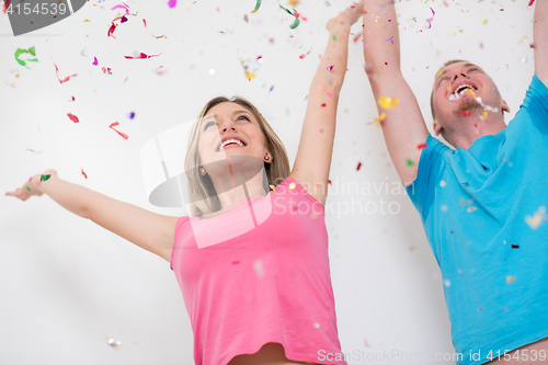 Image of romantic young  couple celebrating  party with confetti