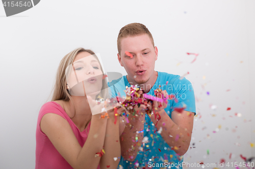 Image of romantic young  couple celebrating  party with confetti