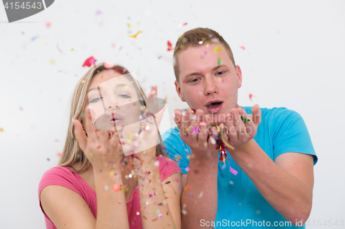 Image of romantic young  couple celebrating  party with confetti