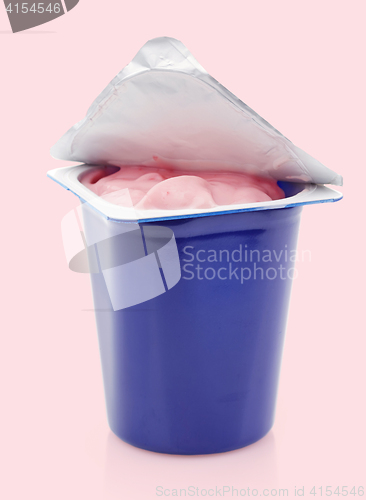 Image of fresh pink berry yogurt in blue plastic pot