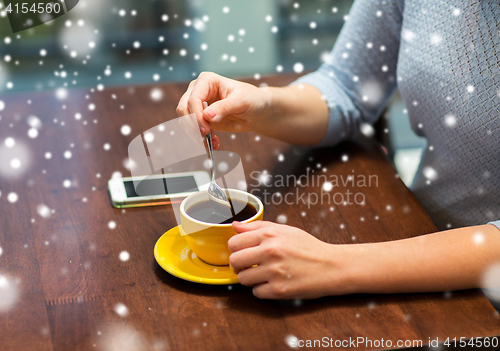 Image of close up of woman with smartphone and coffee