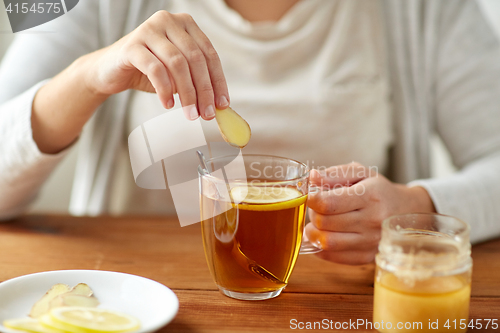 Image of close up of ill woman drinking tea with ginger