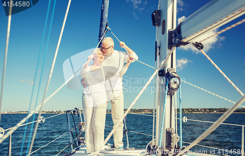 Image of senior couple hugging on sail boat or yacht in sea