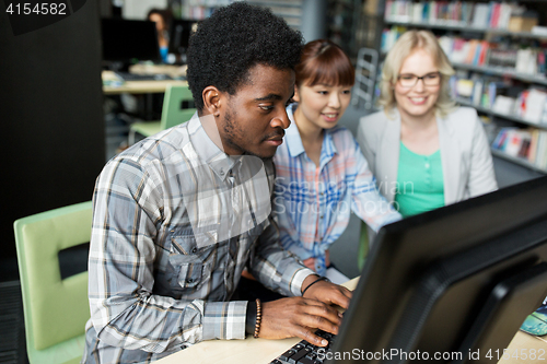 Image of international students with computers at library