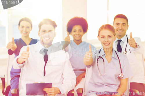 Image of group of happy doctors on seminar at hospital