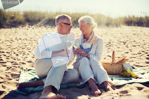 Image of happy senior couple talking on summer beach