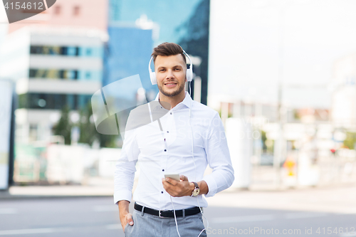 Image of man with headphones and smartphone listening music