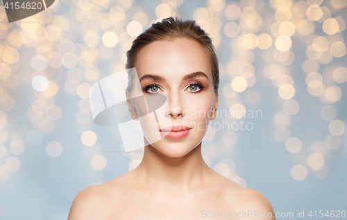 Image of beautiful young woman face over white background