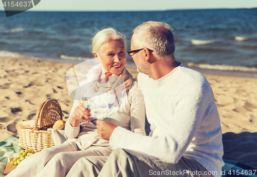 Image of happy senior couple talking on summer beach