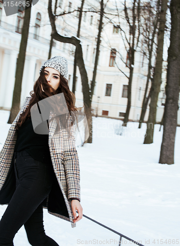 Image of young pretty stylish modern hipster girl outside on street, fash