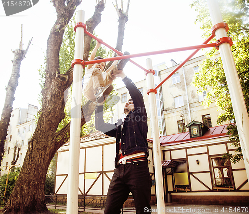 Image of Father with son on playground training, happy real family smiling outside, lifestyle people concept