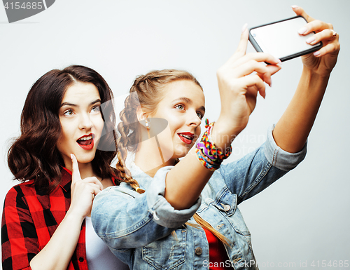 Image of lifestyle and people concept: Fashion portrait of two stylish sexy girls best friends, over white background. Happy time for fun.