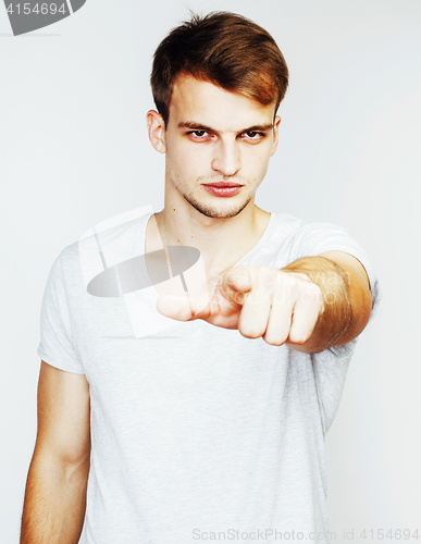 Image of young handsome man on white background gesturing, pointing, posi