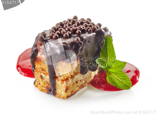 Image of biscuit cake with chocolate and strawberry sauce