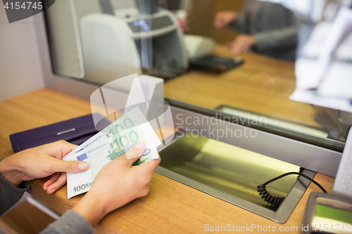 Image of hands with money at bank or currency exchanger