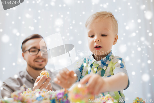 Image of father and son playing with ball clay at home