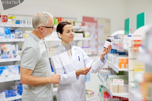 Image of pharmacist and senior man buying drug at pharmacy