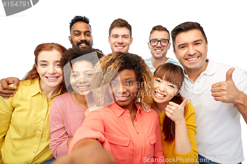 Image of international group of happy people taking selfie