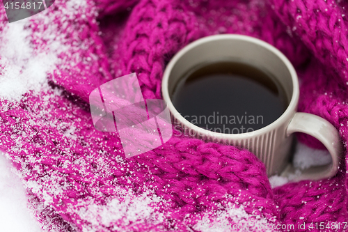 Image of close up of tea or coffee and winter scarf in snow