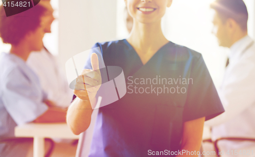 Image of close up of doctor showing thumbs at hospital