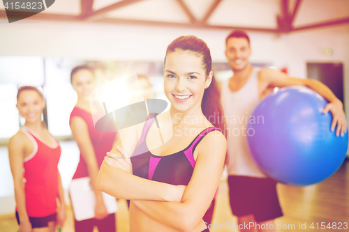 Image of woman standing in front of the group in gym