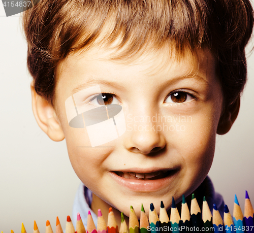 Image of little cute boy with color pencils close up smiling, education f