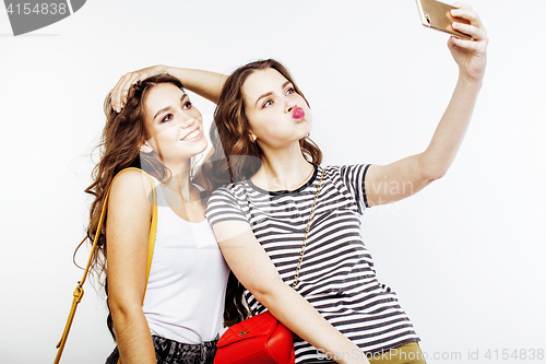 Image of two best friends teenage girls together having fun, posing emotional on white background, besties happy smiling, making selfie, lifestyle people concept