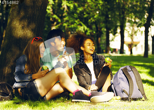 Image of cute group of teenages at the building of university with books 