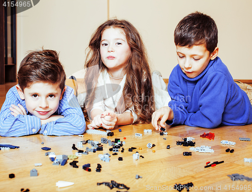 Image of funny cute children playing lego at home, boys and girl smiling, first education role lifestyle