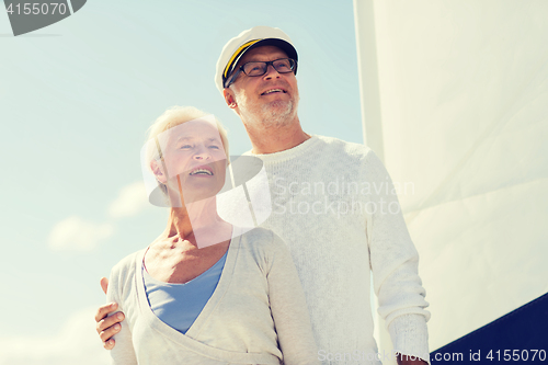 Image of senior couple hugging on sail boat or yacht in sea