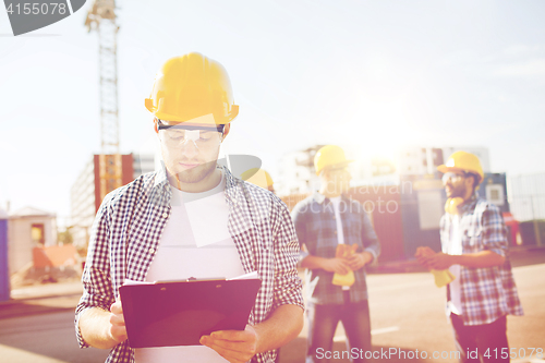 Image of group of builders in hardhats outdoors