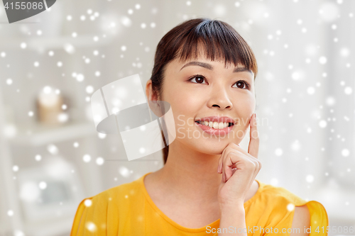 Image of happy asian young dreaming woman face at home